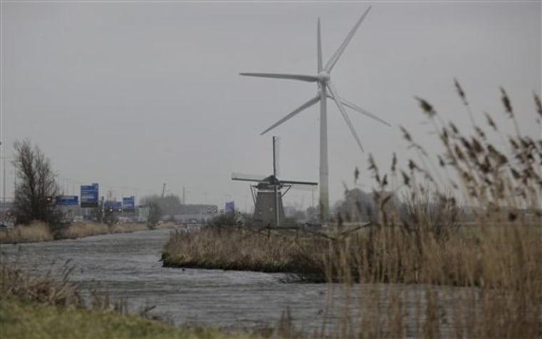 A traditional four-bladed windmill and two modern wind turbines are seen near Leiden, Netherlands. 